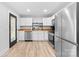Bright kitchen featuring stainless steel appliances, white cabinets, and a contemporary design, creating an efficient space at 2318 Knight Dr, Gastonia, NC 28052