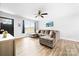 Comfortable living room with a large sectional sofa, ceiling fan, and natural light from a large window at 2318 Knight Dr, Gastonia, NC 28052