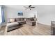 Spacious living room featuring a plush sectional sofa and stylish decor, illuminated by a ceiling fan at 2318 Knight Dr, Gastonia, NC 28052