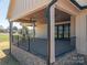 Covered outdoor living space features ceiling fan and brick foundation at 2321 Ivey Church Rd, Maiden, NC 28650