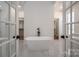 Bright bathroom features a modern tub, dual walk-in closets, and elegant tile flooring at 2321 Ivey Church Rd, Maiden, NC 28650