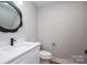 Charming powder room featuring designer mirror and faucet at 2321 Ivey Church Rd, Maiden, NC 28650