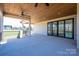 Inviting covered patio with stained wood ceiling, ceiling fans and sliding glass doors to the home's interior at 2321 Ivey Church Rd, Maiden, NC 28650