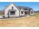 Exterior of the home showcasing dark framed windows, mixed siding and manicured lawn at 2321 Ivey Church Rd, Maiden, NC 28650