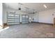 Spacious two car garage with concrete flooring and brick accent walls at 2321 Ivey Church Rd, Maiden, NC 28650