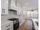 Well-equipped kitchen featuring a gas range, custom hood, and ample storage space at 2321 Ivey Church Rd, Maiden, NC 28650