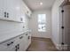 Bright laundry room featuring modern cabinets, countertops, and natural light from a window at 2321 Ivey Church Rd, Maiden, NC 28650