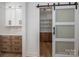 Walk-in pantry with custom cabinets and sliding barn door provides ample storage space and organization at 2321 Ivey Church Rd, Maiden, NC 28650