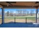 Covered patio featuring a stained wood ceiling with fan, concrete flooring and black metal railings at 2321 Ivey Church Rd, Maiden, NC 28650
