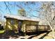 Backyard view showing the deck and siding of this one-story home at 300 Mcalway Rd, Charlotte, NC 28211