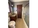 Bathroom featuring a granite vanity, wooden cabinets, and tiled floors and walls at 300 Mcalway Rd, Charlotte, NC 28211