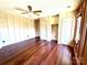 Spacious bedroom featuring hardwood floors, closet, and wall paneling at 300 Mcalway Rd, Charlotte, NC 28211