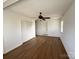 Bedroom featuring hardwood floors, ceiling fan, closet and an exterior door at 300 Mcalway Rd, Charlotte, NC 28211