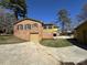 Exterior view of a brick home with a separate garage and driveway at 300 Mcalway Rd, Charlotte, NC 28211
