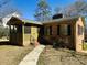 Inviting brick home featuring a cozy screened-in porch and walkway at 300 Mcalway Rd, Charlotte, NC 28211