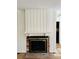 Elegant fireplace with brick hearth and white paneled walls in living room at 300 Mcalway Rd, Charlotte, NC 28211