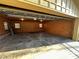 Inside the open detached garage, a concrete slab is exposed as well as the unfinished walls at 300 Mcalway Rd, Charlotte, NC 28211