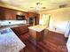 Traditional kitchen with a center island, wood cabinets, granite countertops, and hardwood flooring at 300 Mcalway Rd, Charlotte, NC 28211