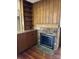 Living room with brick fireplace, wood paneling, and built-in bookshelves at 300 Mcalway Rd, Charlotte, NC 28211