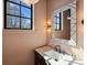 Chic powder room with unique mirror, stylish vanity, and natural light from window at 3203 Maymont Pl, Charlotte, NC 28205