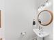 Clean half bathroom featuring a white vanity, modern faucet, and decorative mirror at 4114 Rutgers Ave, Charlotte, NC 28206