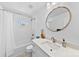 Bright bathroom features a tub with a shower, and white cabinets at 4114 Rutgers Ave, Charlotte, NC 28206
