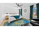 Bright bedroom featuring a large window, accent rug, ceiling fan, and natural light at 4114 Rutgers Ave, Charlotte, NC 28206