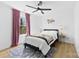 Bright bedroom features a gray bed frame and pink curtains at 4114 Rutgers Ave, Charlotte, NC 28206