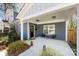 Inviting covered front porch with stylish seating area and freshly manicured plants at 4114 Rutgers Ave, Charlotte, NC 28206