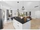 Well-lit kitchen open to the living area, featuring a center island and stainless steel appliances at 4114 Rutgers Ave, Charlotte, NC 28206