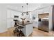 Modern kitchen with white cabinets, stainless steel appliances, and a central island with seating at 4114 Rutgers Ave, Charlotte, NC 28206