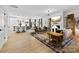 Bright open-concept living room with stylish furniture, fireplace, and wood floors at 4114 Rutgers Ave, Charlotte, NC 28206