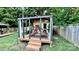 Outdoor backyard structure with wooden deck, draped curtains, string lights, and lounge chairs at 4342 Valeview Ln, Charlotte, NC 28269