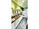 Olive green bathroom with dual sinks, black marble countertop, and shower/tub combo at 4342 Valeview Ln, Charlotte, NC 28269