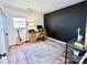 Functional office with a desk, computer, guitar, and large area rug, perfect for work or hobbies at 4342 Valeview Ln, Charlotte, NC 28269