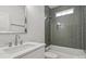 A bathroom featuring gray tile shower, tub, and a white marble vanity at 501 Everette St, Monroe, NC 28112