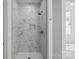 Bathroom shower featuring gray marble tile, a built-in niche, and modern fixtures at 501 Everette St, Monroe, NC 28112