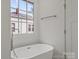 Bright bathroom with a freestanding tub, large window, and modern fixtures at 501 Everette St, Monroe, NC 28112