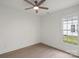 Cozy bedroom featuring hardwood floors, a ceiling fan, and large windows at 501 Everette St, Monroe, NC 28112