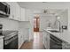 Bright kitchen with stainless appliances, island sink, and white cabinetry at 501 Everette St, Monroe, NC 28112
