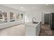 Bright kitchen with stainless appliances, island sink, and white cabinetry at 501 Everette St, Monroe, NC 28112