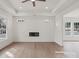 Open concept living room featuring recessed lighting, fireplace, and hardwood floors at 501 Everette St, Monroe, NC 28112