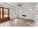 Bright living room featuring modern fireplace, tray ceiling, and hardwood floors at 501 Everette St, Monroe, NC 28112