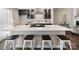 Modern kitchen island with a quartz countertop, seating, and sleek cabinetry in a stylish home at 5530 Great Wagon Rd, Charlotte, NC 28215