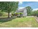 Expansive backyard features a lush lawn, mature trees, and a screened-in porch at 6141 Abergele Ln, Matthews, NC 28104