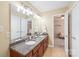 En suite bathroom featuring double sinks with granite counters, and access to bedroom and closet at 6141 Abergele Ln, Matthews, NC 28104