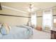 Bedroom features neutral walls and carpet, a ceiling fan, and bright white curtains at 6141 Abergele Ln, Matthews, NC 28104
