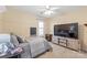 Comfortable bedroom featuring neutral tones, wainscoting, and large flat screen television at 6141 Abergele Ln, Matthews, NC 28104