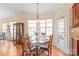 A sunlit breakfast nook with a rustic round table and wood chairs at 6141 Abergele Ln, Matthews, NC 28104