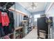 Organized walk-in closet with ample storage shelves, rods, and a window for natural light at 6141 Abergele Ln, Matthews, NC 28104